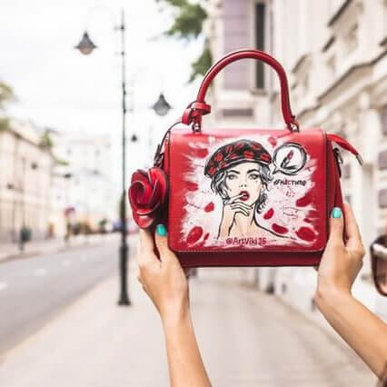 woman-holding-her-red-and-white-leather-handbag-up-high-at-2304764 woman-holding-her-red-and-white-leather-handbag-up-high-at-2304764